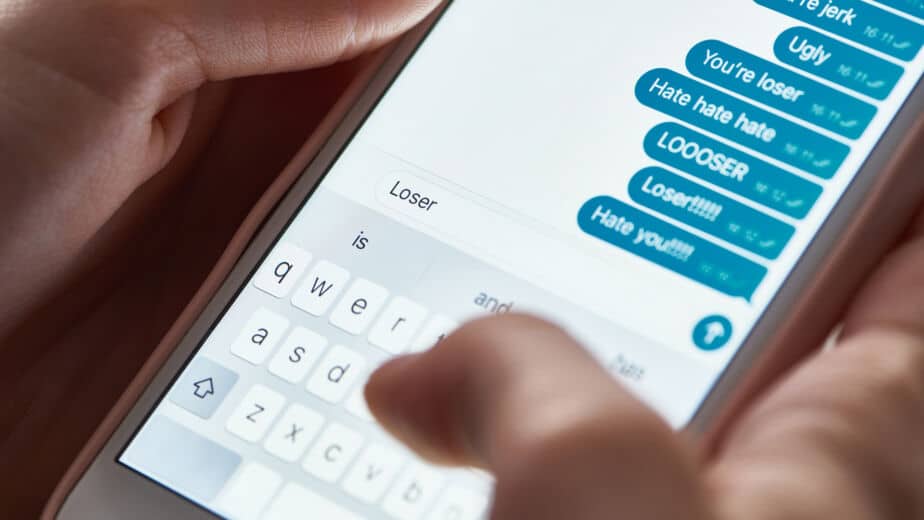 Forensic examiner connecting a smartphone to a workstation to recover deleted text messages